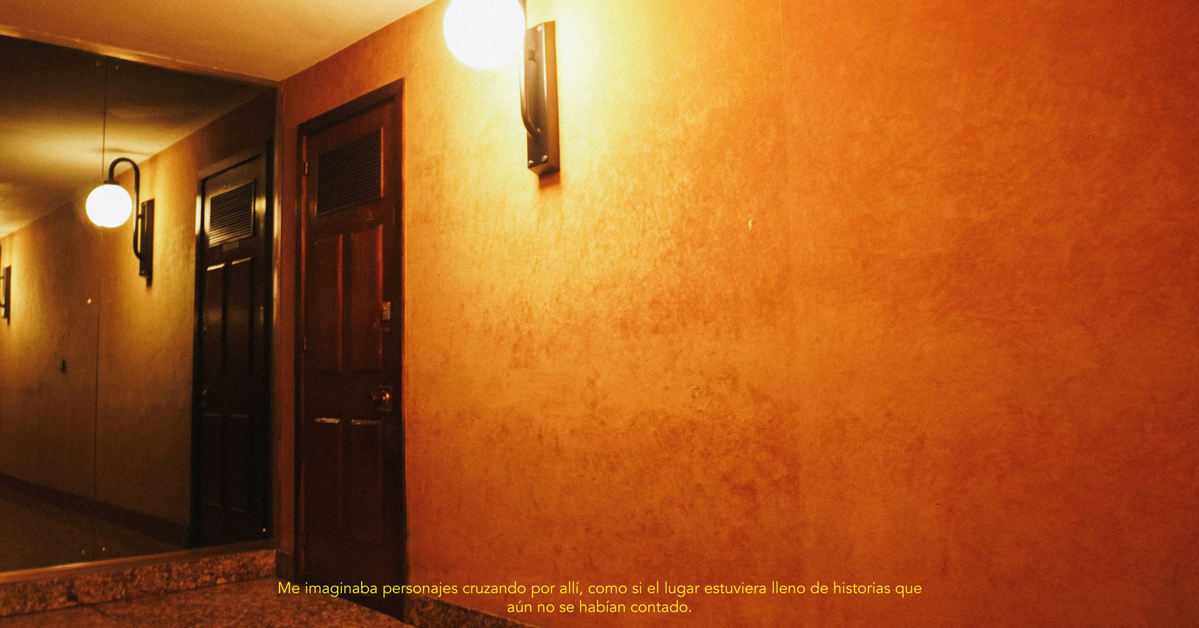 Pasillo de hotel con lámparas y puerta de madera